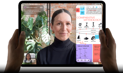 iPad Pro, front exterior, landscape orientation, space black colour, rounded corners, black display bezel, hands holding left and right sides, display showing a FaceTime conversation being live translated, and an educational app showing a presentation of “Comparative Mythology” with text, diagrams and handwritten notes
