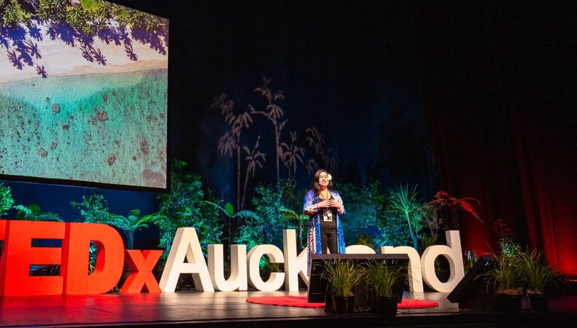 A woman onstage speaking at TEDxAuckland tūmanako