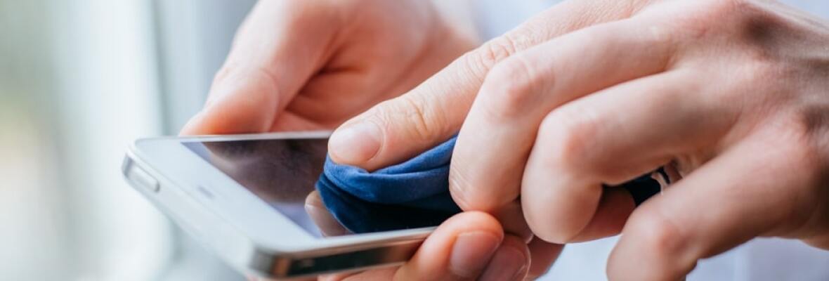 Person cleaning his mobile phone