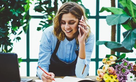 Florist taking order over the phone from customer