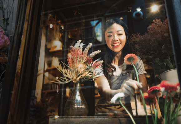 smiling florist working at her shop