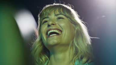 Girl with short hair happily watching a movie