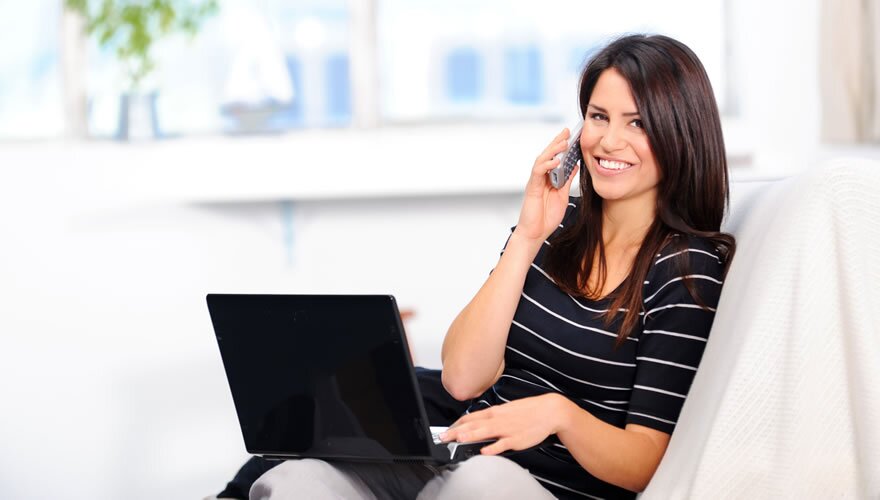 Woman talking on the pone with laptop