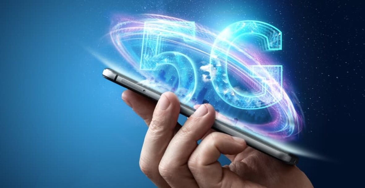 Person holding mobile phone with a 5G logo