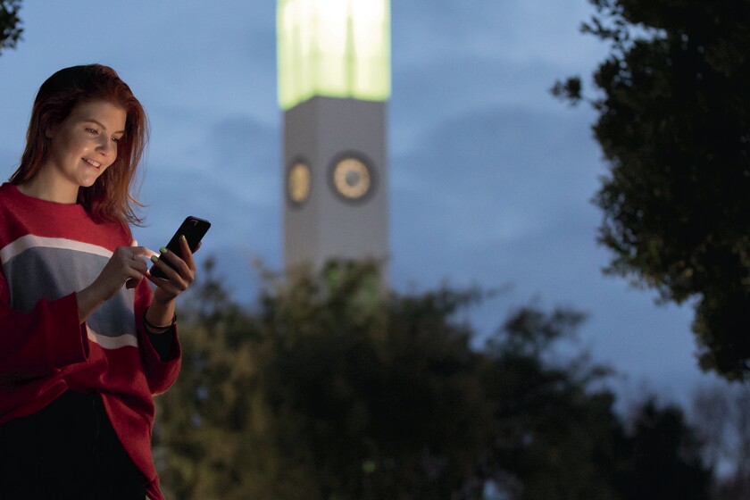 A smiling lady, checking her phone in Manawatu.
