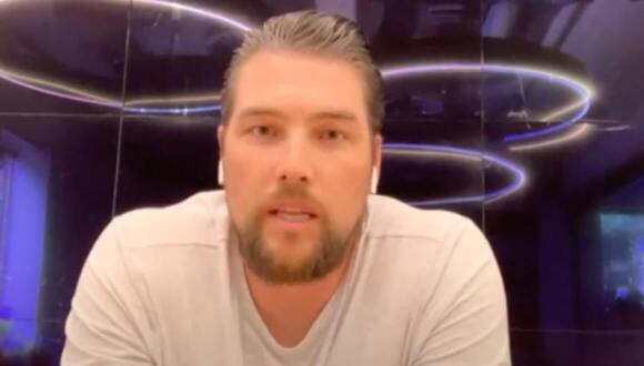 Man looking towards camera and talking