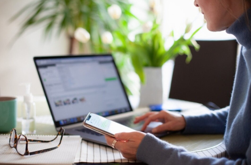 Lady using laptop and mobile phone in an office