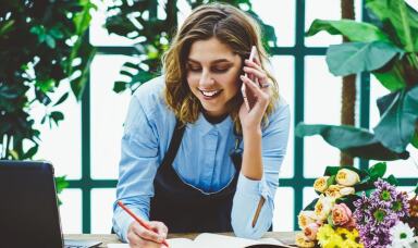 Florist taking order over the phone from customer