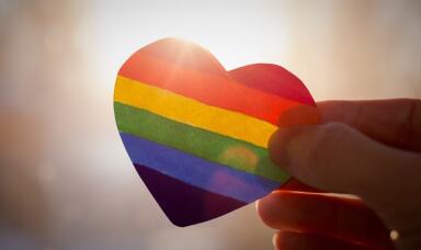 Person holding rainbow heart