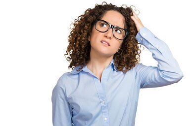 A woman looking puzzled and scratching her head