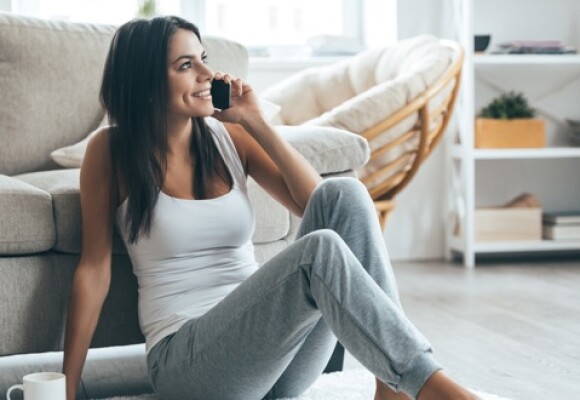 Person sitting and talking on the phone