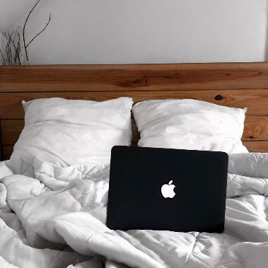 apple laptop on bed