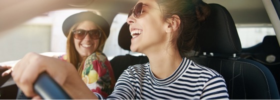 Two women in a car, one driving, one in the passenger's seat