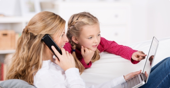 Woman and her daughter looking at a laptop.