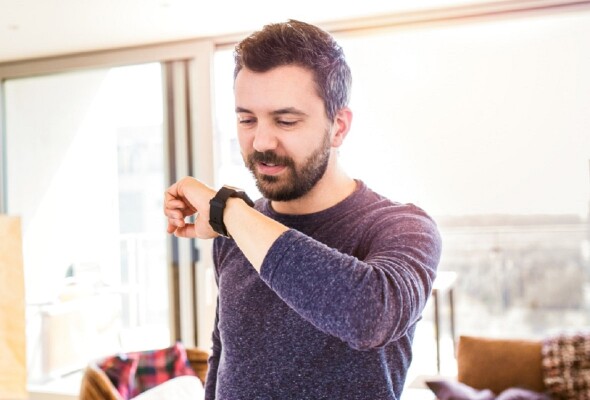 A man checks his smart watch