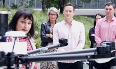 People looking at a drone