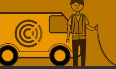 man with a wire standing in front of a van