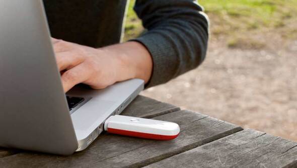 Employee working on a laptop outside