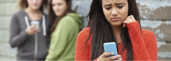 A woman looking upset and something on at her phone