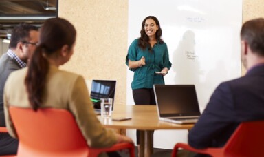 Woman in an office showing presentation to collegaues