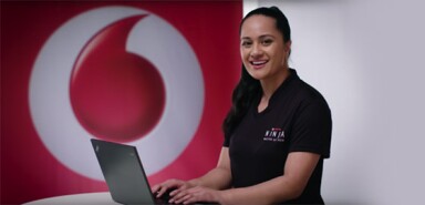 A female Vodafone Ninja types on her laptop