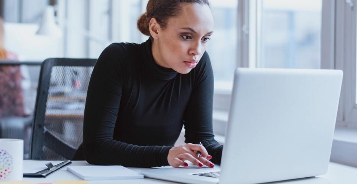 Woman looking at a laptop in an office