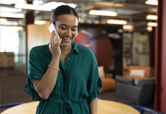 Woman talking on her mobile phone in the office