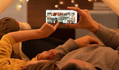 Two people looking at videos on a mobile phone