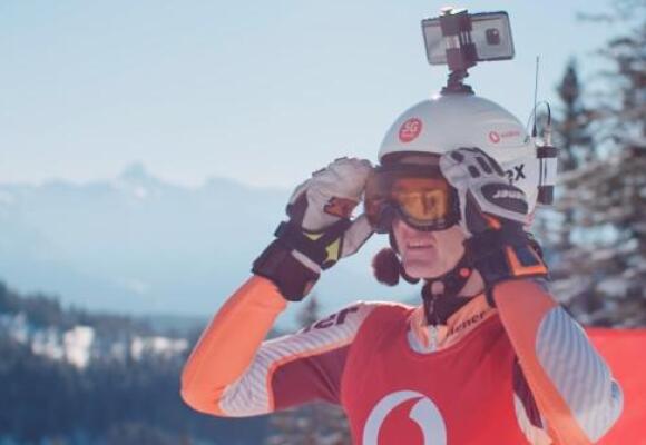 Person wearing T-Shirt with Vodafone Logo and a phone in his helmet