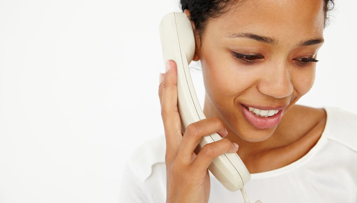 Woman talking on a landline phone