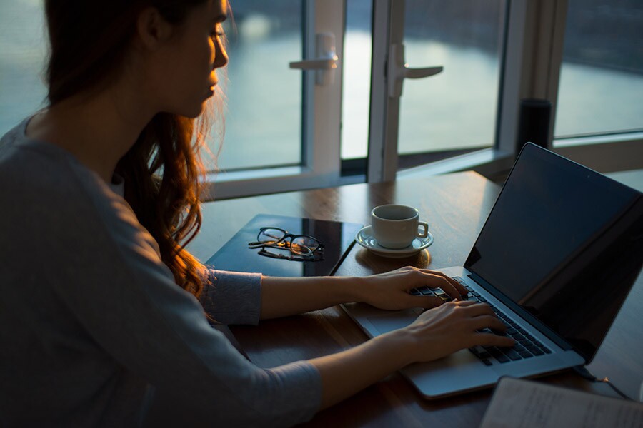 A woman with her laptop, working from home.