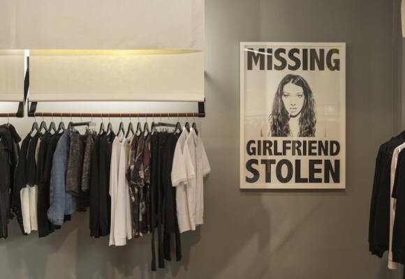Store showing a stolen girlfriends poster and rack of clothes