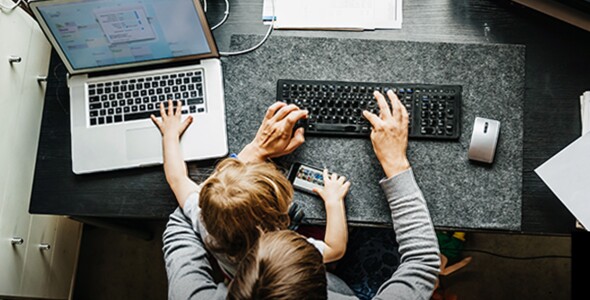 parent working from home with child on lap