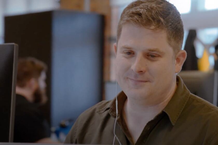 Person looking at his monitor wearing mic