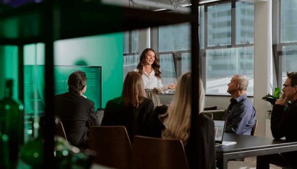 A woman standing and presenting in front of a group of people