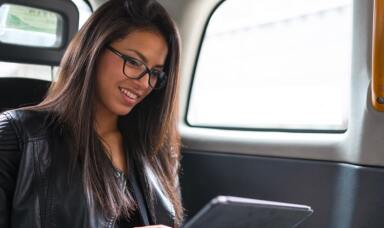 Lady looking at a tablet in a car