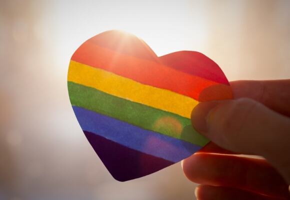Person holding rainbow heart