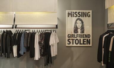 Store showing a stolen girlfriends poster and rack of clothes
