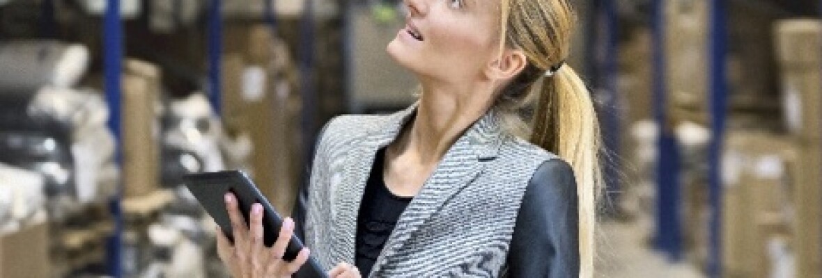 Woman holding a tablet in a warehouse