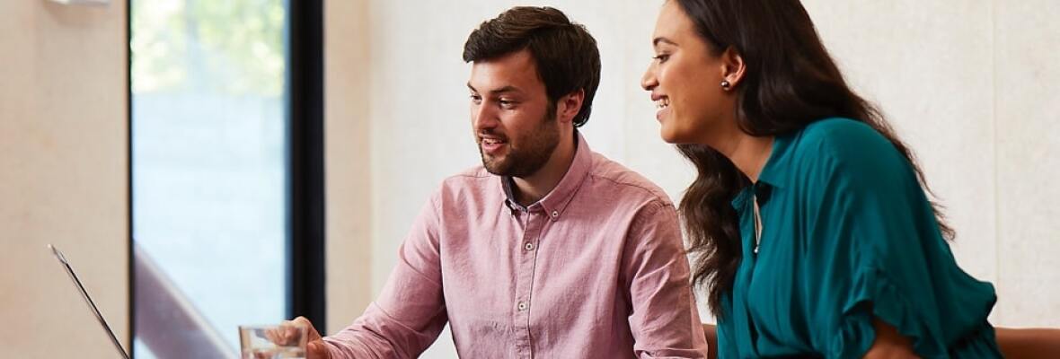 Man and woman looking at a laptop
