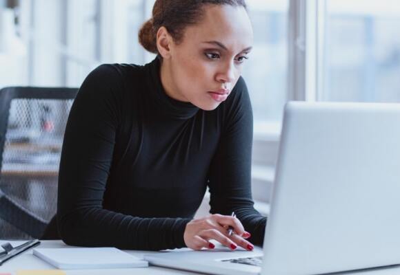 Woman looking at a laptop in an office