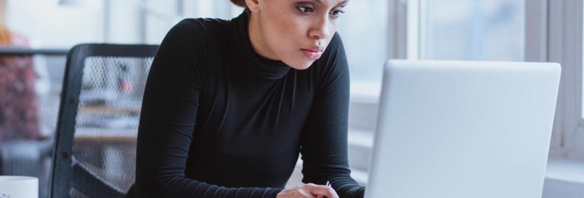 Woman looking at a laptop in an office