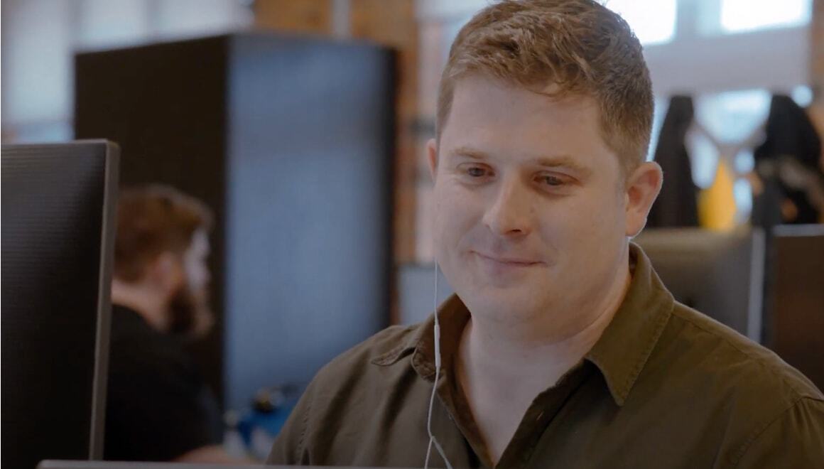 Person looking at his monitor wearing mic