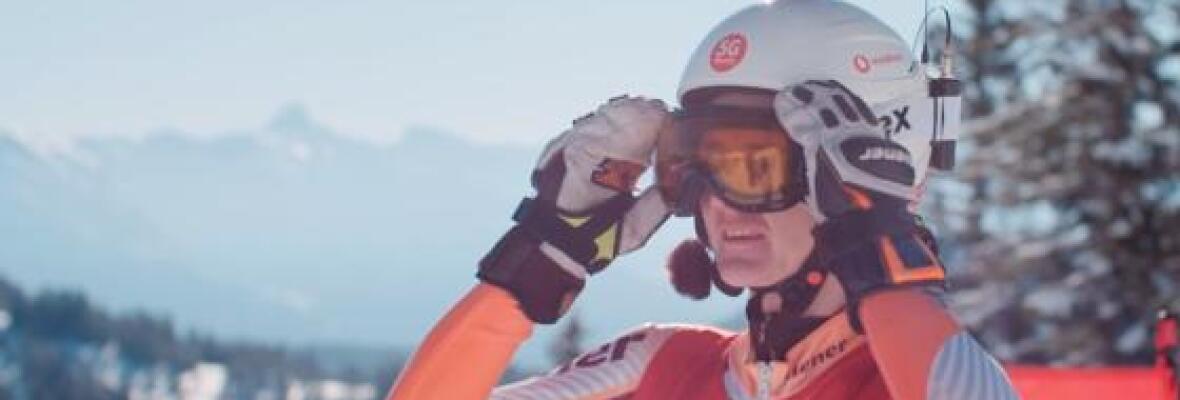 Person wearing T-Shirt with Vodafone Logo and a phone in his helmet