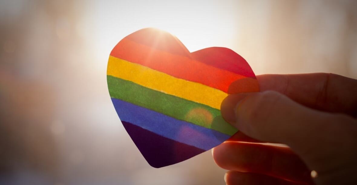 Person holding rainbow heart