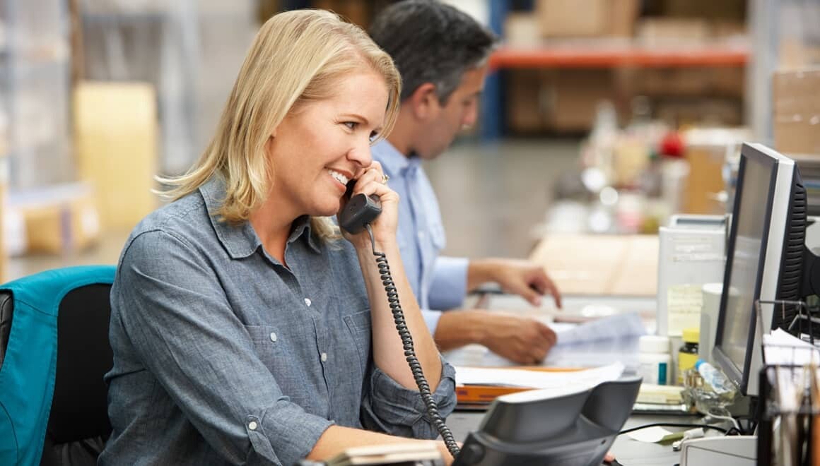 Woman talking on VOIP phone in office