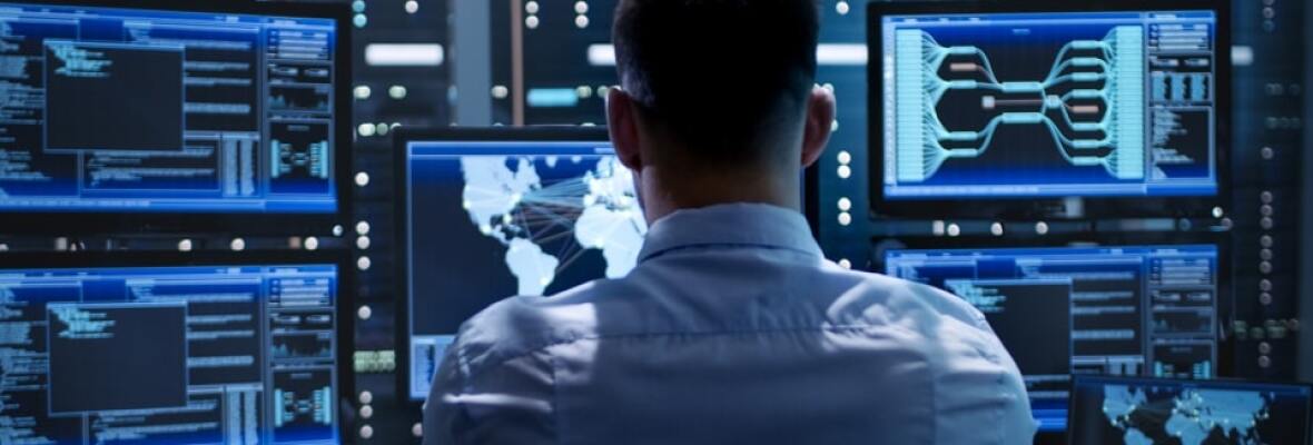 Man looking at multiple computer screens