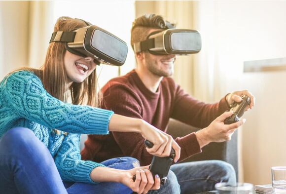 two people wearing VR head gear playing games