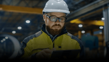 A man using a 5G capable tablet inside a warehouse.