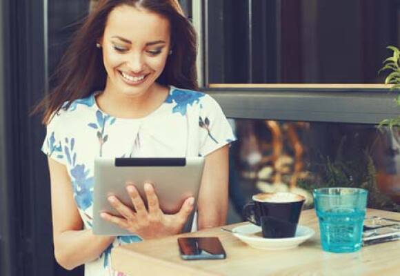 Person using a tablet at a cafe